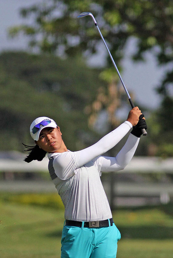 Yuka Saso hits her approach shot on the opening hole.