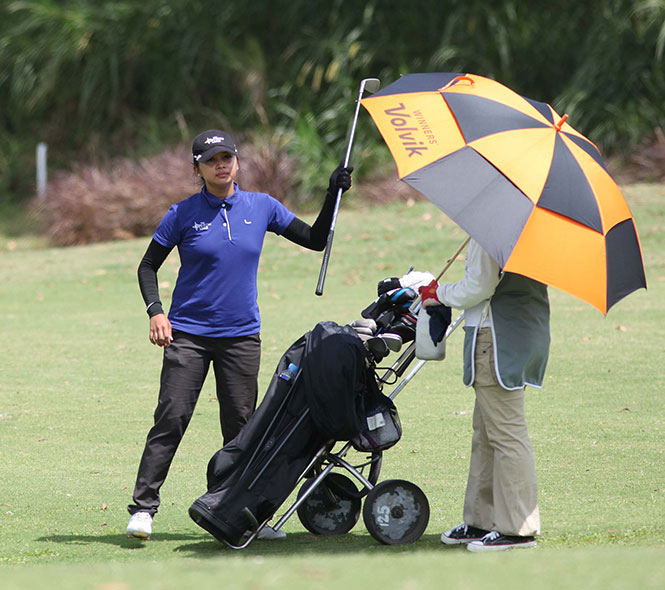 Princess Superal picks up a club for her third shot on the par-5 ninth hole.