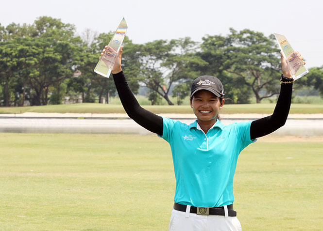 Young Bernice Olivarez-Ilas raises her twin trophies after bagging the overall crown and the low amateur honors.