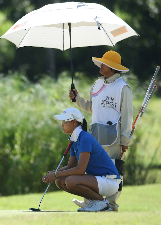 Cyna Rodriguez reads the line of her putt on No. 12