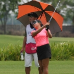 del rosaario in hole 14 fairway looking in his caddie her father bong del rosario