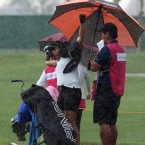 del rosario rush in to put rain coat during sudden heavy rain in the cpourse