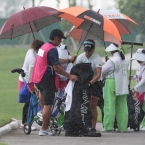 del rosario rushing in to cover their bags after a heavy rain