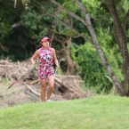 saruttaya hole 9 fairway with her 2 clubs while study her next shots